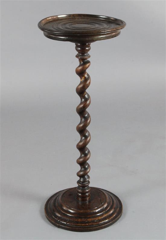 A 17th century fruitwood candle stand on spiral-turned column, H.2ft 3in. Diam. 11in. (some restoration)